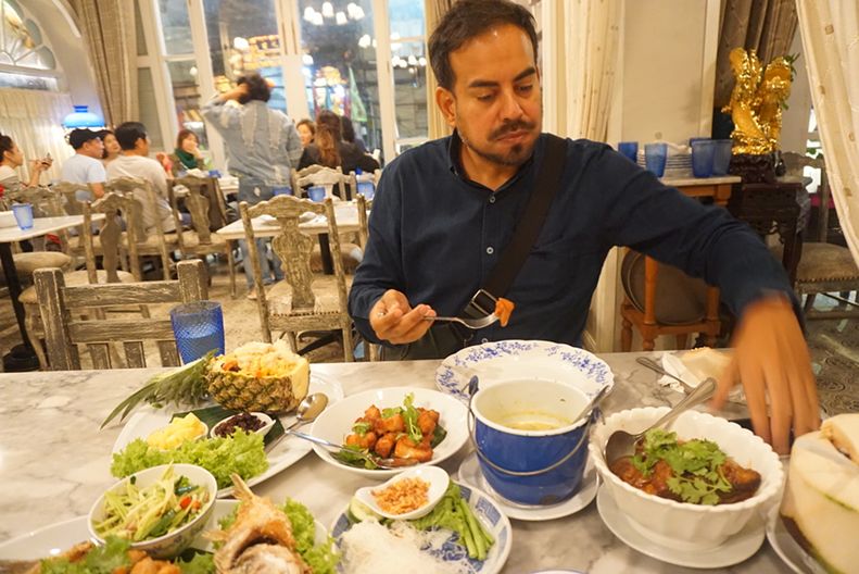Danny Mosquera at a restaurant table set with dishes